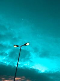 Low angle view of street light against blue sky