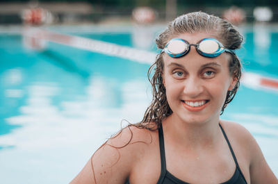 Portrait of smiling young woman in swimming in pool