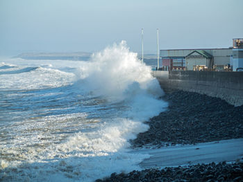 Waves pounding westward ho sea defenses 