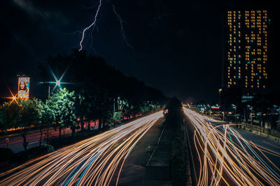 Light trails on road in city at night