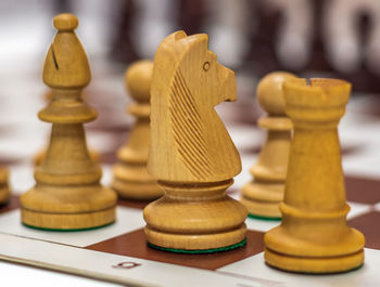 Close-up of chess pieces on table