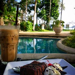 Close-up of food on table by swimming pool