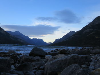 Scenic view of sea and mountains against sky