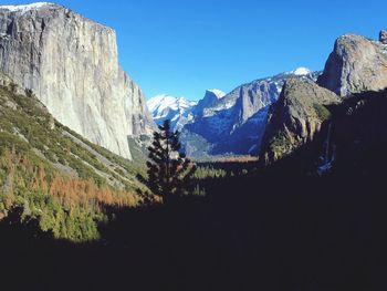 Low angle view of mountains against clear blue sky