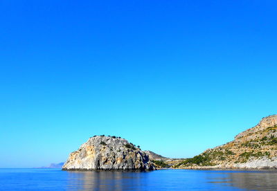 Scenic view of sea against clear blue sky