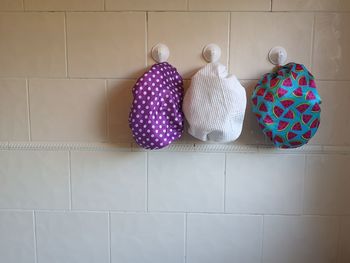Shower caps hanging on wall at home
