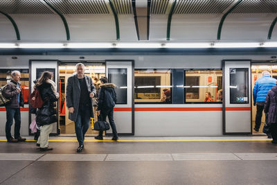 People waiting at railroad station platform
