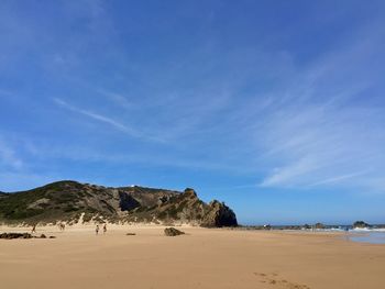 Scenic view of desert against blue sky