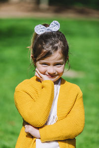 Portrait of cute smiling girl standing in park