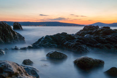Scenic view of sea against cloudy sky