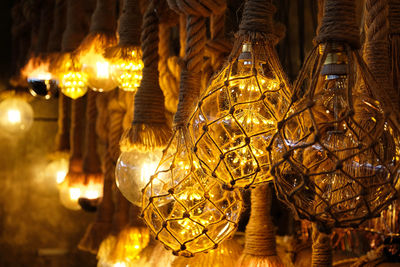 Close-up of illuminated lamp hanging at night