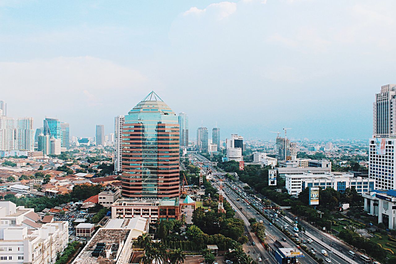 building exterior, architecture, city, built structure, cityscape, transportation, road, high angle view, street, car, sky, residential district, residential building, city life, land vehicle, residential structure, city street, building, the way forward, outdoors