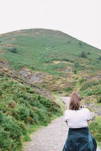 Rear view of woman standing on mountain