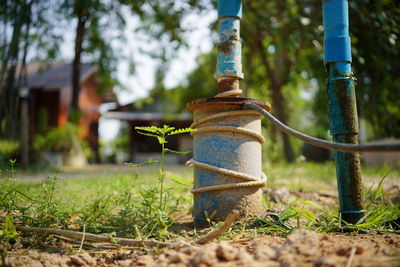 Close-up of rusty pipe on field