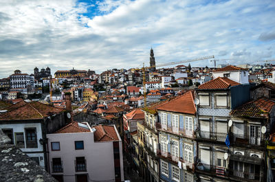 View of cityscape against cloudy sky