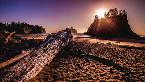 Scenic view of beach against sky during sunset