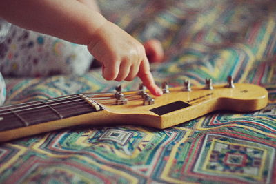 Close-up of hands playing piano at home