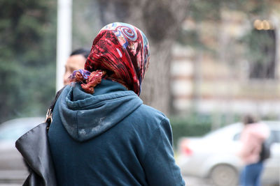 Rear view of people walking on street