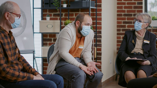 Side view of business colleagues working at office