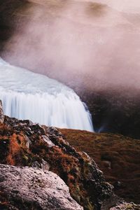 Scenic view of waterfall against sky