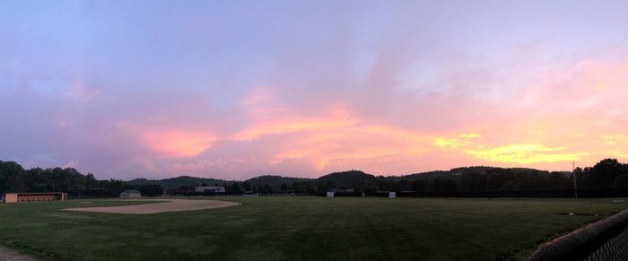 Scenic view of dramatic sky over land during sunset