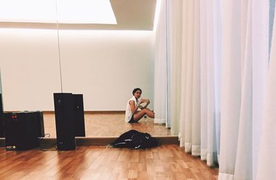 Young man sitting in corridor