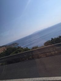 Road by mountain against sky