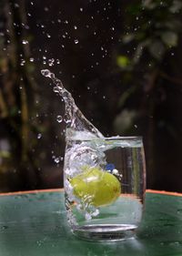 Close-up of water splashing in glass