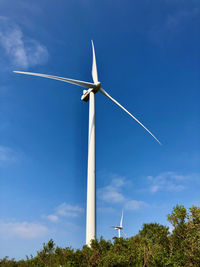 Low angle view of windmill against sky