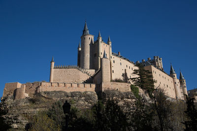 Low angle view of church against clear blue sky