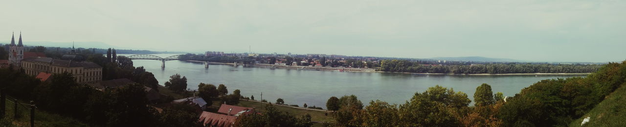 Scenic view of river and mountains against sky