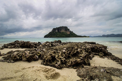 Rocks on beach against sky