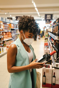 Man holding camera while standing in store