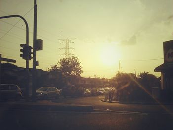 Cars on road at sunset