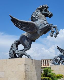 Low angle view of statue against sky