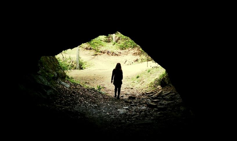 full length, rear view, standing, walking, lifestyles, men, silhouette, tranquility, leisure activity, nature, tunnel, rock - object, person, tranquil scene, unrecognizable person, solitude, day, outdoors