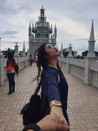 Midsection of a woman with city in the background