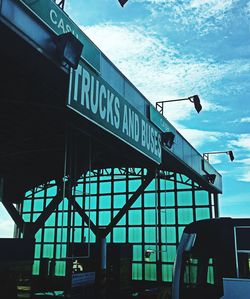 Low angle view of road sign against sky