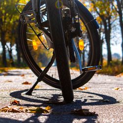 Close-up of bicycle parked on footpath in park