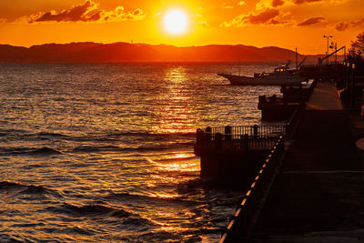 Scenic view of sea against orange sky