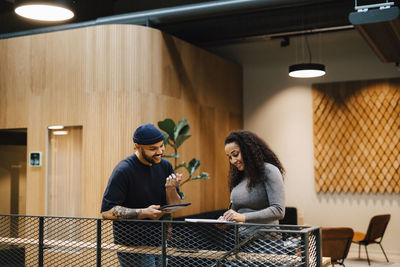 Coworkers talking at corridor