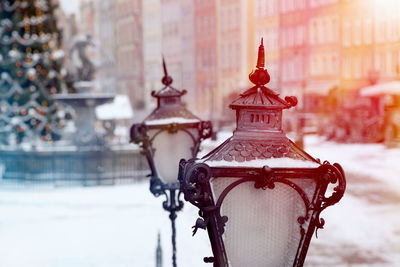 Close-up of street lights against buildings