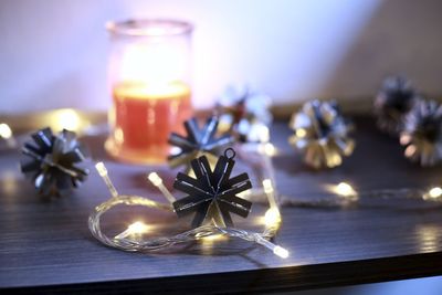 Close-up of illuminated candles on table