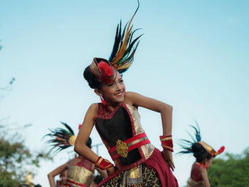 Full length of woman dancing against sky