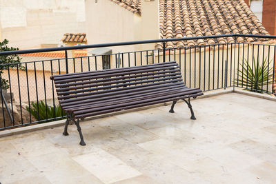 Empty benches against wall of building