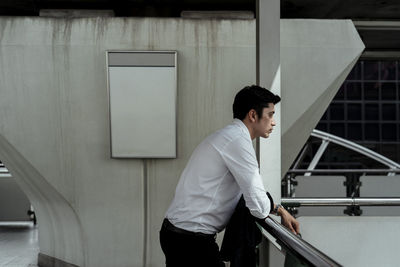 Low angle view of businessman standing in city