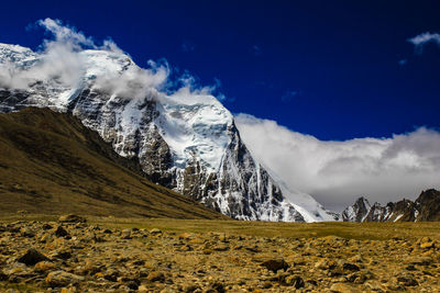 Scenic view of snowcapped mountains against blue sky