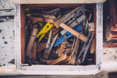 Close-up of clothespins in wooden container