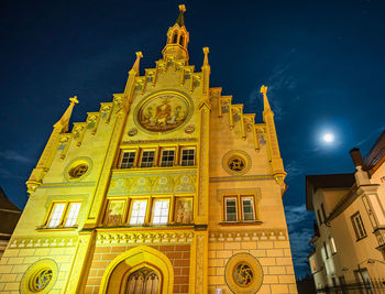 Low angle view of illuminated building against sky at night