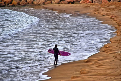 Full length of woman standing on rocks